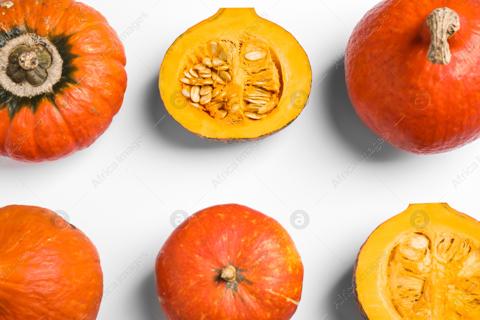 Photo of Fresh ripe pumpkins on white background, top view. Holiday decoration