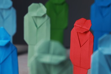 Many colorful paper figures on table, closeup. Recruiter searching employee