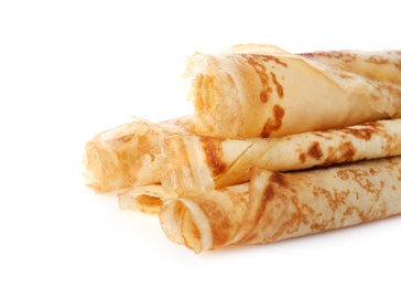 Photo of Tasty thin pancake rolls on white background