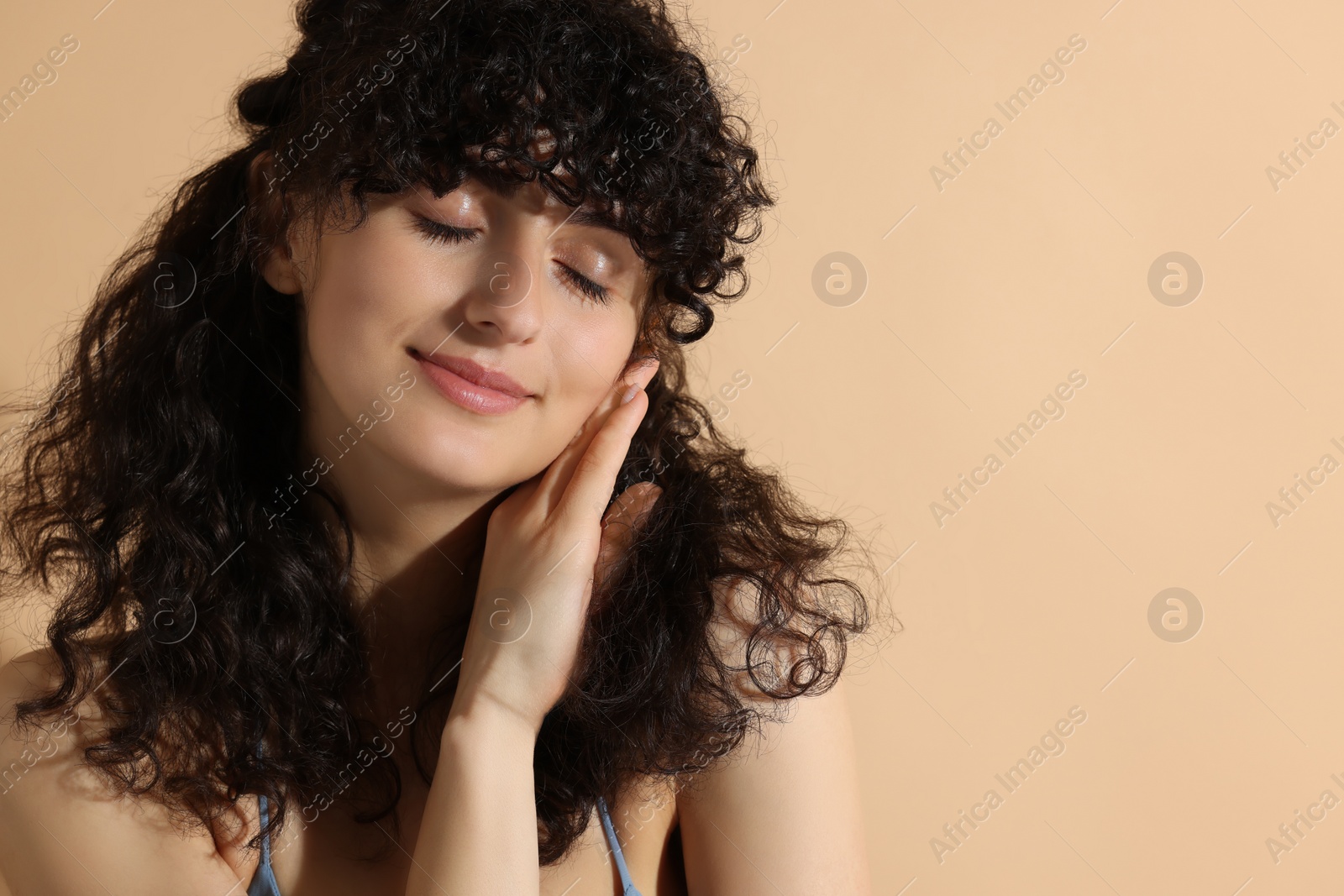 Photo of Beautiful young woman on beige background, space for text
