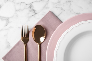 Beautiful table setting on white marble background, flat lay