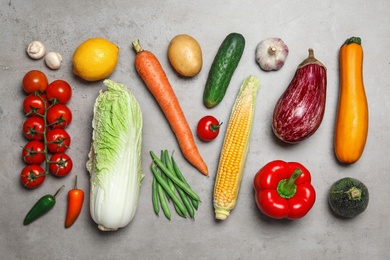 Photo of Flat lay composition of different fresh vegetables on grey table