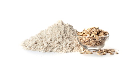 Photo of Bowl with oat flakes and flour isolated on white