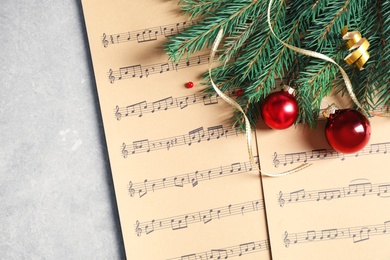 Flat lay composition with Christmas decorations and music sheets on table