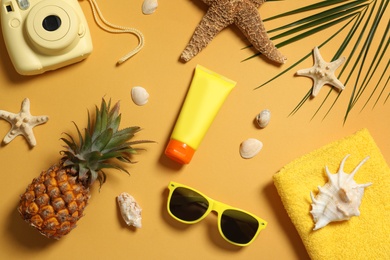 Flat lay composition with beach accessories on color background