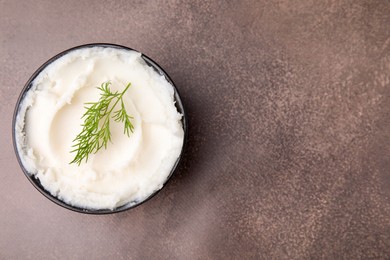 Delicious pork lard with dill in bowl on brown table, top view. Space for text