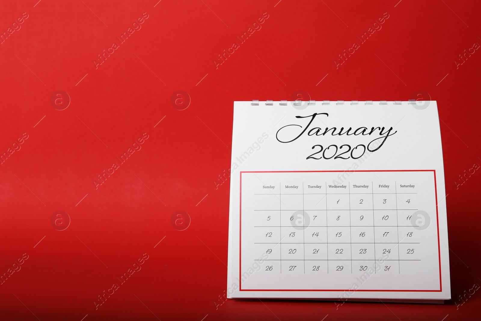 Photo of Paper calendar on red background. Planning concept