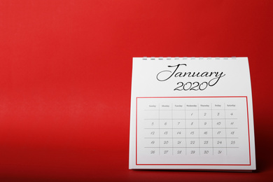 Photo of Paper calendar on red background. Planning concept