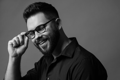 Photo of Portrait of handsome bearded man on grey background. Black and white effect