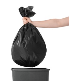 Photo of Woman holding trash bag full of garbage over bucket on white background, closeup