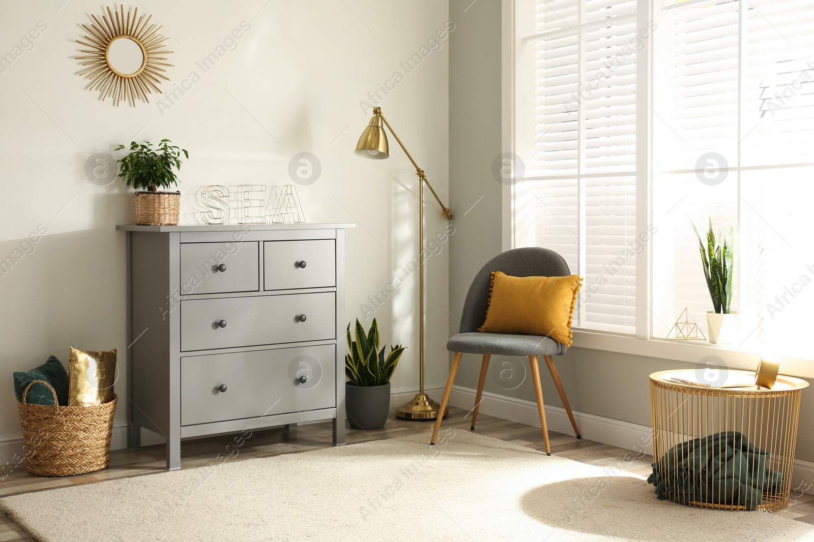 Photo of Grey chest of drawers in stylish room interior