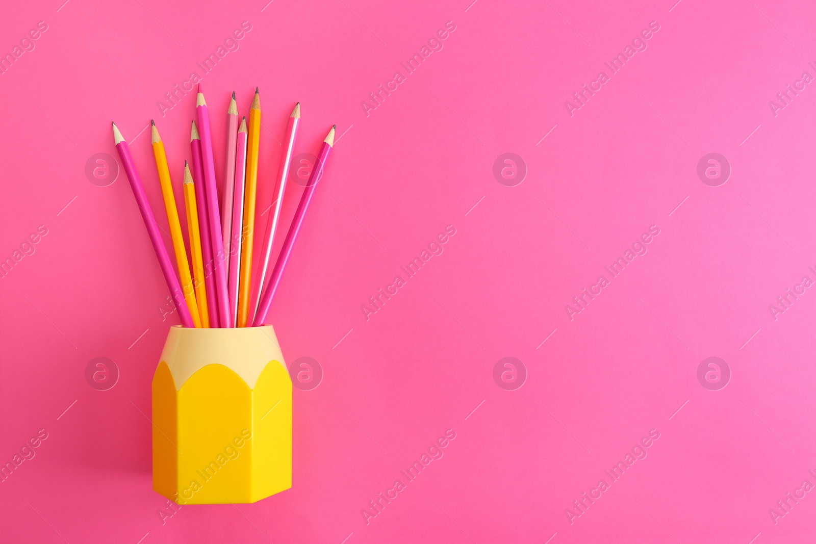 Photo of Flat lay composition with colorful pencils on pink background. Space for text