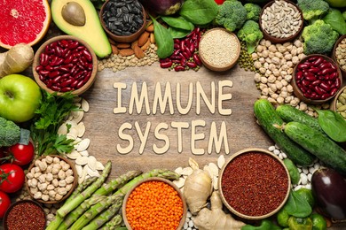 Image of Immune system boosting with proper nutrition. Different foods on wooden table, flat lay