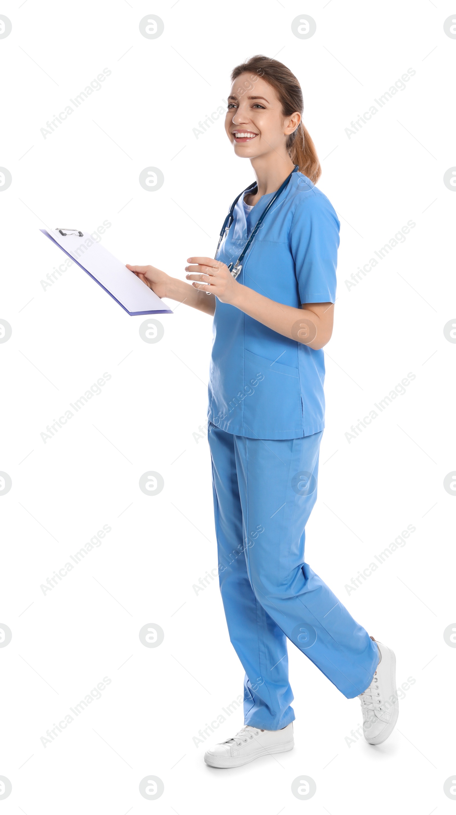 Photo of Full length portrait of medical doctor with clipboard and stethoscope isolated on white