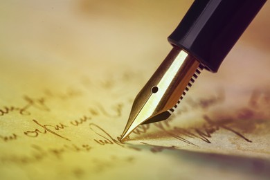 Writing letter with fountain pen, closeup. Space for text