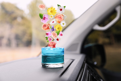 Image of Air freshener on dashboard in car. Flowered aroma
