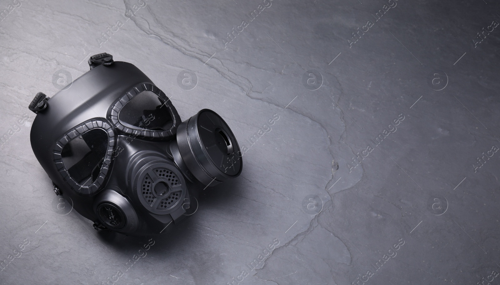 Photo of One gas mask on grey textured background, top view. Space for text