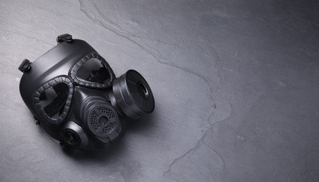 Photo of One gas mask on grey textured background, top view. Space for text