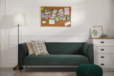 Photo of Stylish living room interior with vision board and sofa