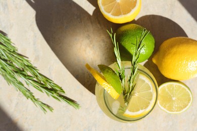 Summer refreshing lemonade and ingredients on light grey table, flat lay. Space for text