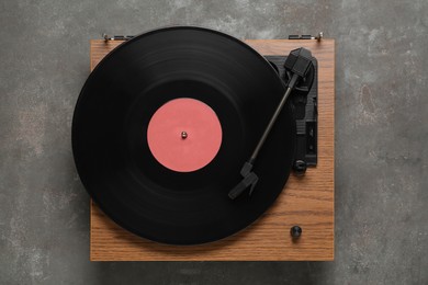 Photo of Turntable with vinyl record on grey background, top view