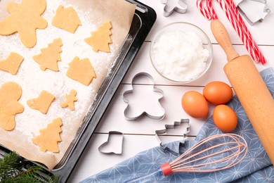 Photo of Making Christmas cookies. Flat lay composition with raw dough and ingredients on white wooden table