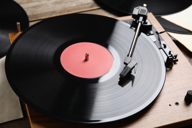 Photo of Modern player and vinyl records, closeup view