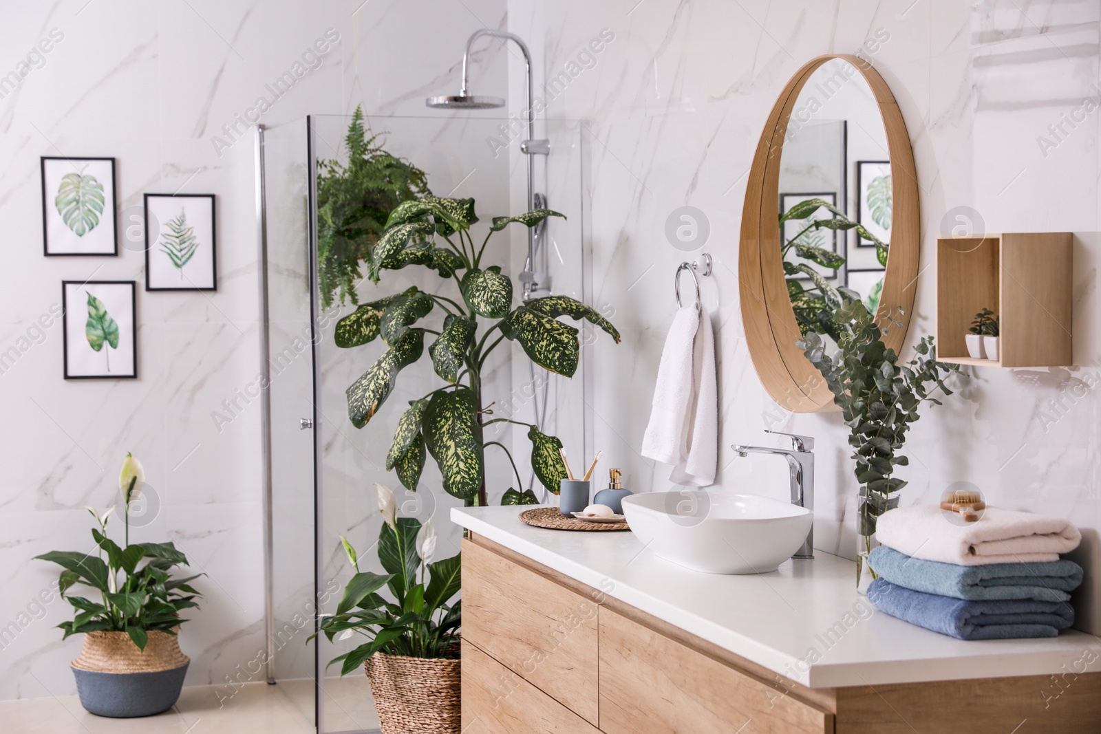 Photo of Green plants in elegant modern bathroom. Interior design