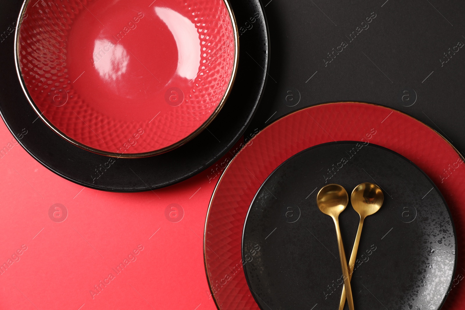 Photo of Stylish table setting with plates and spoons on color background, top view