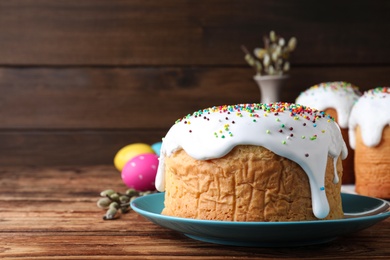 Photo of Traditional decorated Easter cake on wooden background, closeup. Space for text