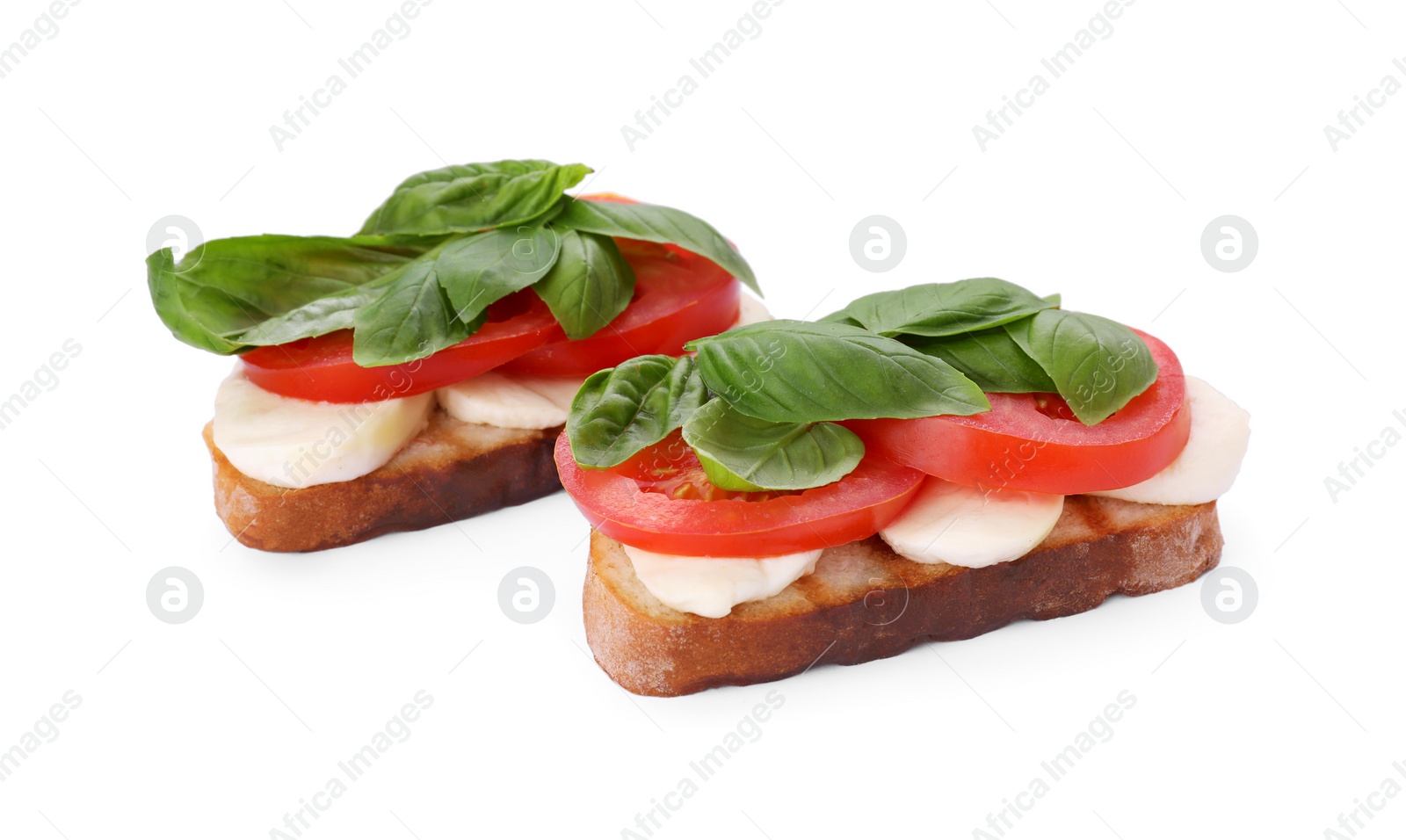 Photo of Delicious Caprese sandwiches with mozzarella, tomatoes and basil isolated on white