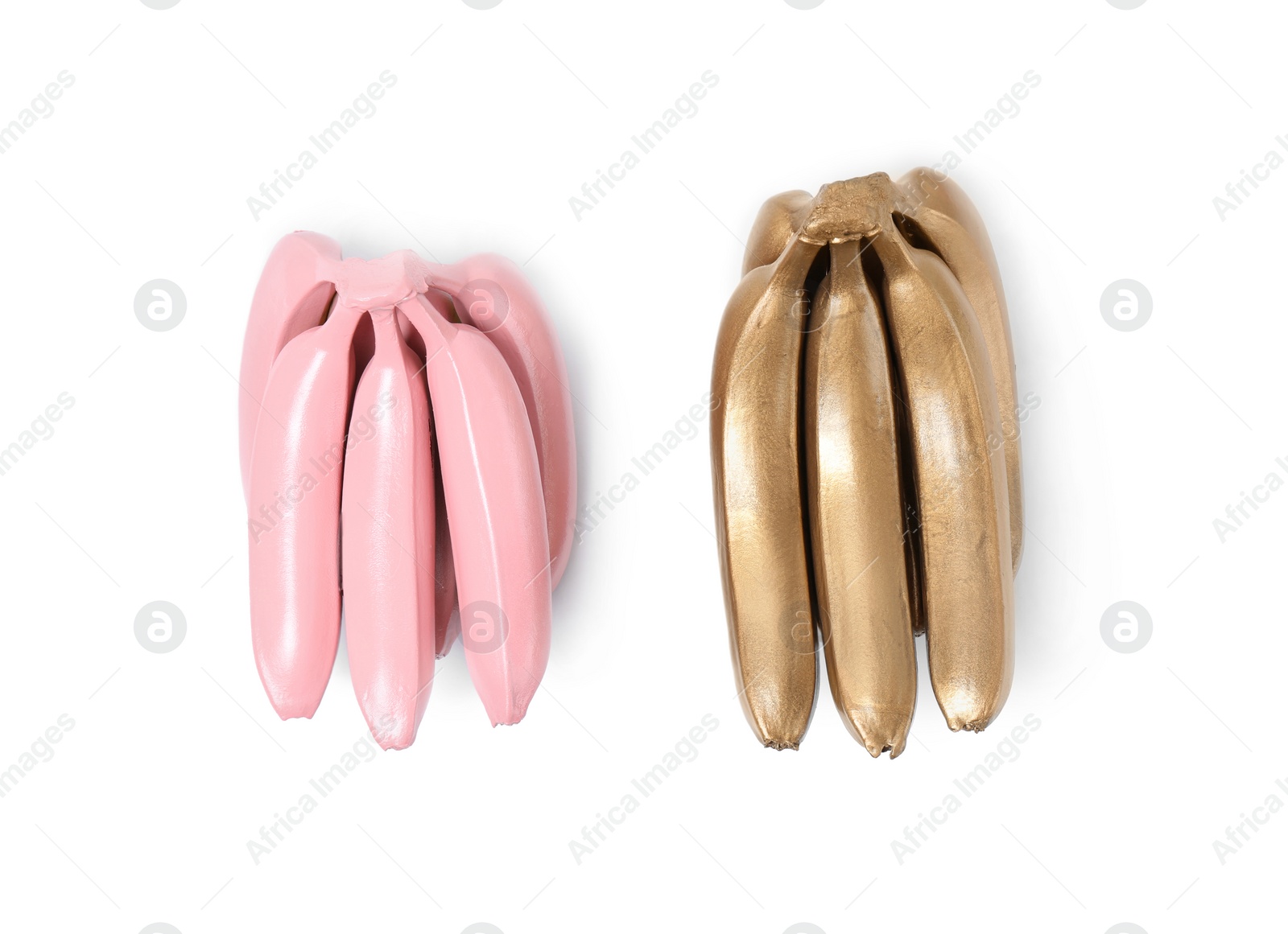 Photo of Stylish gold and pink bananas on white background, top view
