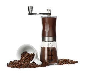 Modern manual coffee grinder with powder, beans and cup on white background