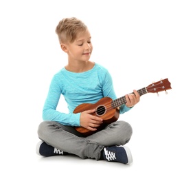 Little boy playing guitar isolated on white
