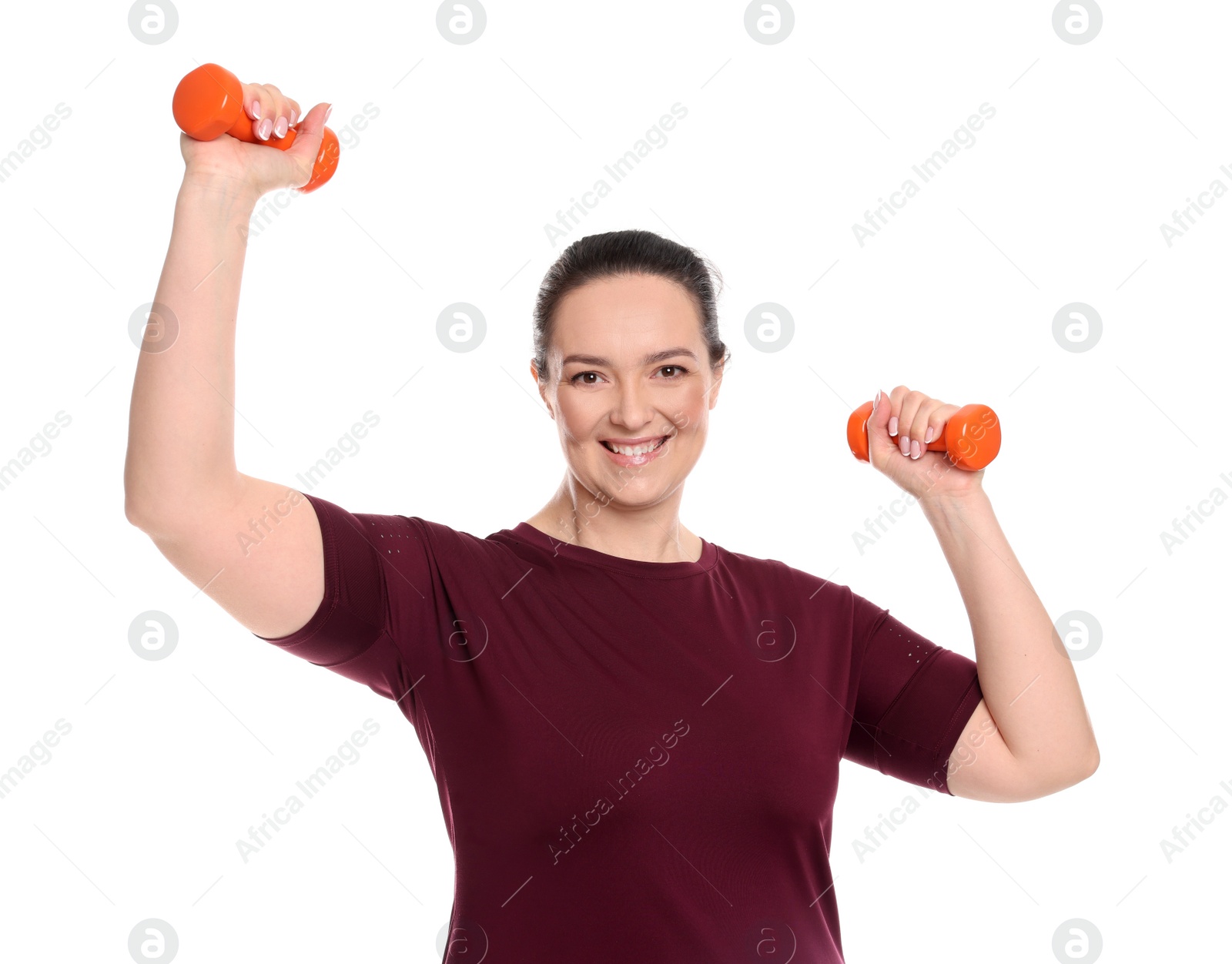 Photo of Happy overweight woman doing exercise with dumbbells on white background