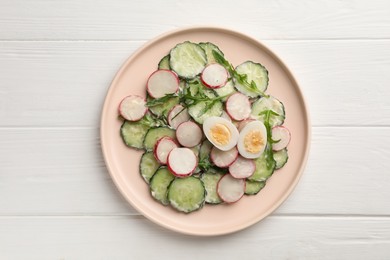 Photo of Tasty fresh salad with cucumber on white wooden table, top view