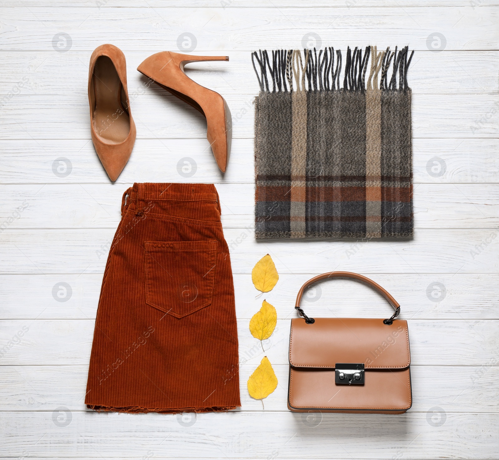 Photo of Flat lay composition with stylish clothes and accessories on white wooden background