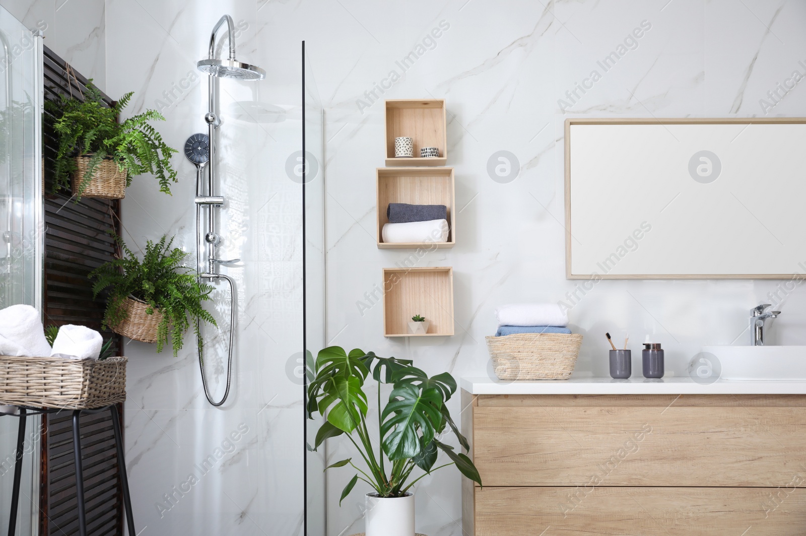 Photo of Bathroom interior with shower stall, counter and houseplants. Idea for design