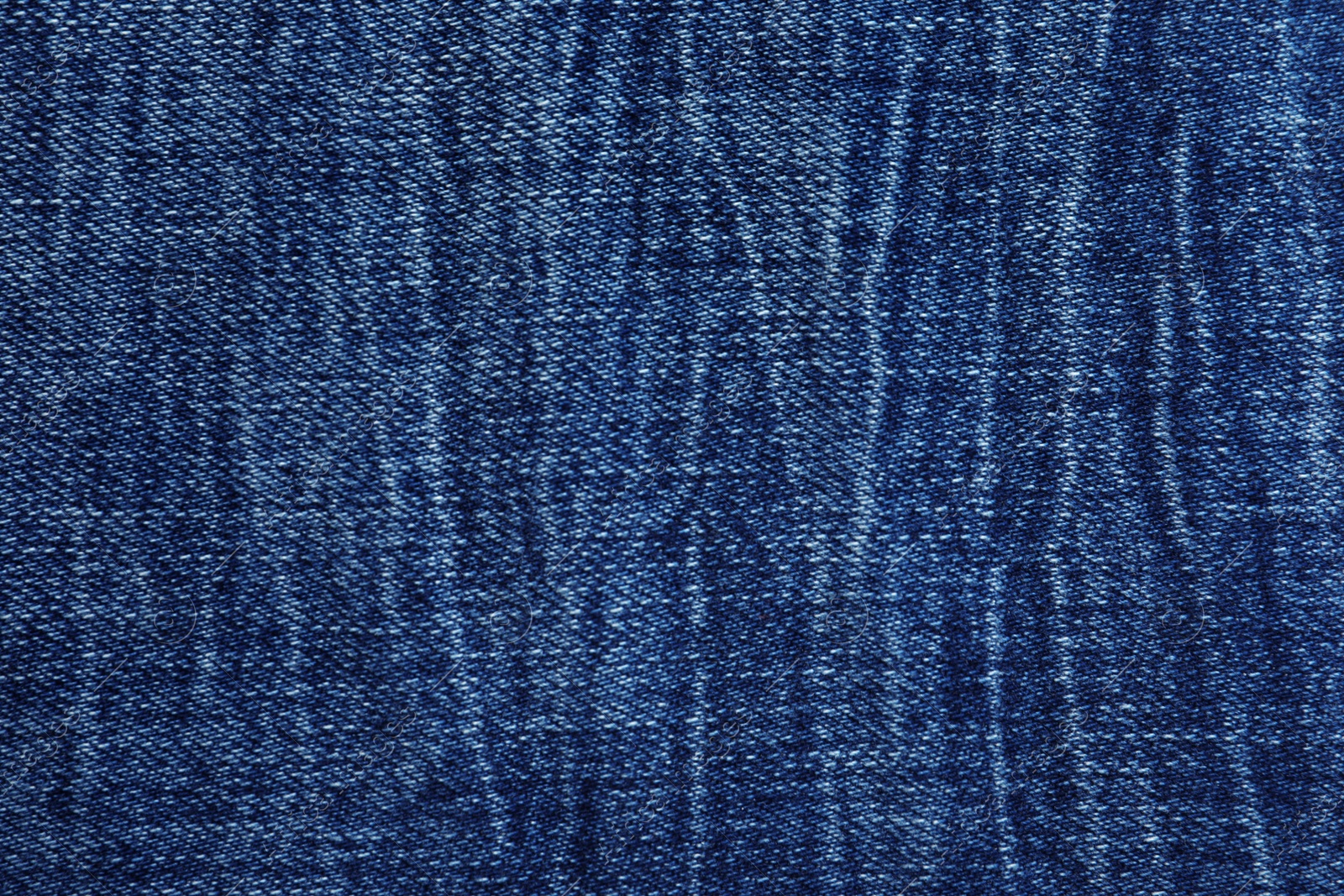 Photo of Texture of dark blue jeans as background, closeup