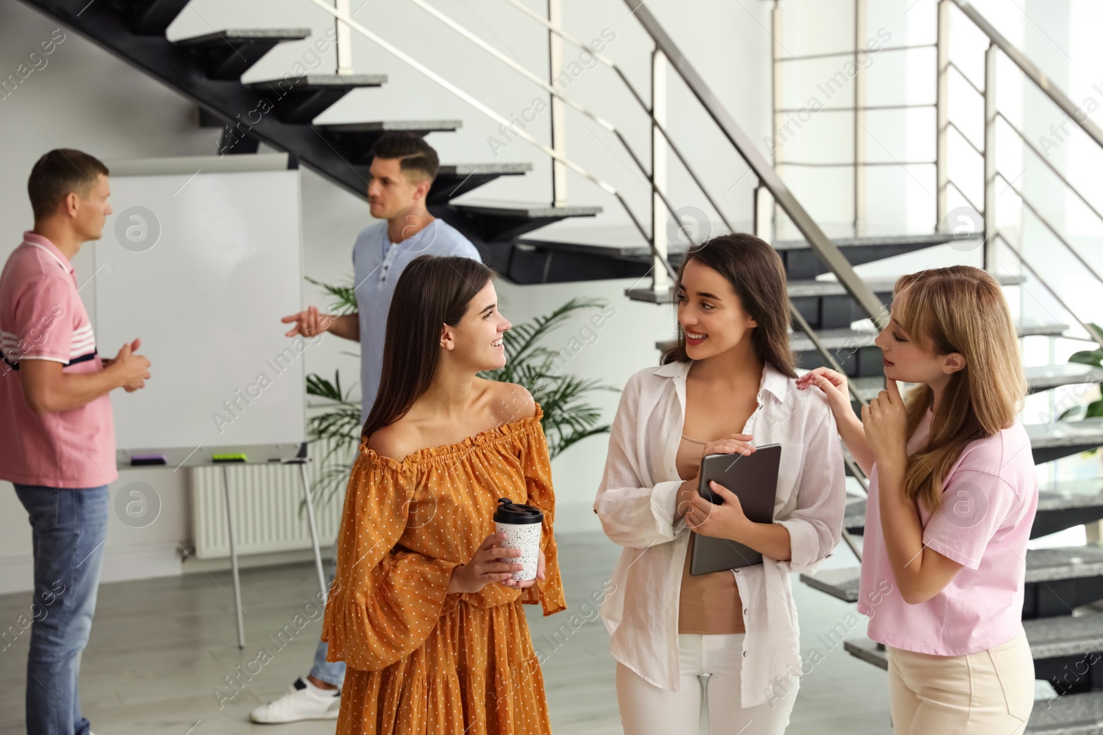 Photo of Group of women having conversation in hall