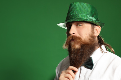 Bearded man in green hat on color background, space for text. St. Patrick's Day celebration