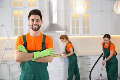 Professional janitor in uniform indoors. Cleaning service