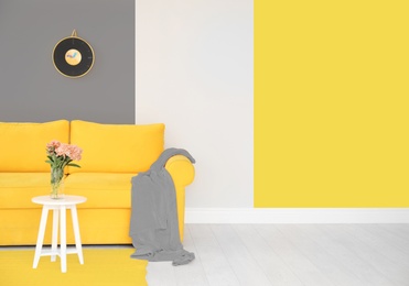 Color of the year 2021.Elegant living room interior with yellow sofa