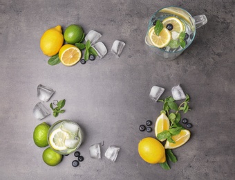 Photo of Flat lay composition with detox lemonade and ingredients on grey background