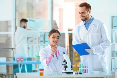 Photo of Young scientists working in laboratory. Chemical analysis