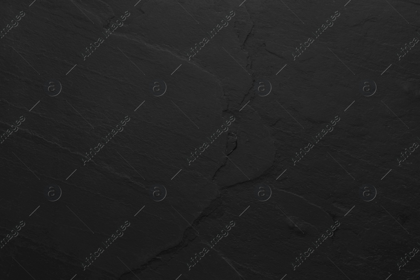 Photo of Texture of black stone surface as background, closeup