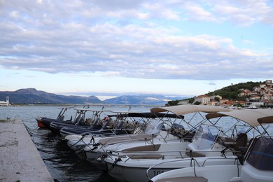 Photo of Picturesque view of mountains, town, moored boats and sea