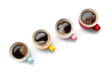 Photo of Row of cups with aromatic coffee on white background, top view
