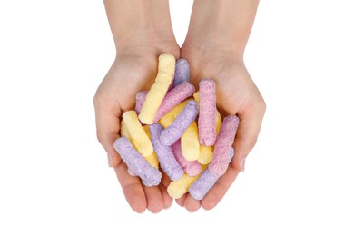 Woman holding colorful corn puffs on white background, top view