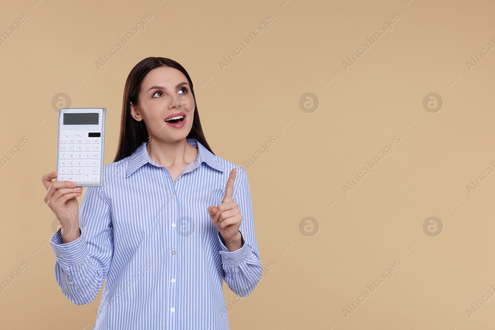 Photo of Young female accountant with calculator on beige background, space for text